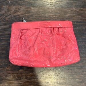 Pink coach clutch